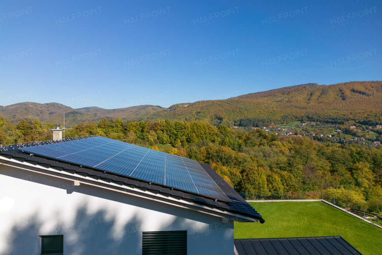 High angle view of solar photovoltaic panels on a roof, alternative energy, saving resources and sustainable lifestyle concept.