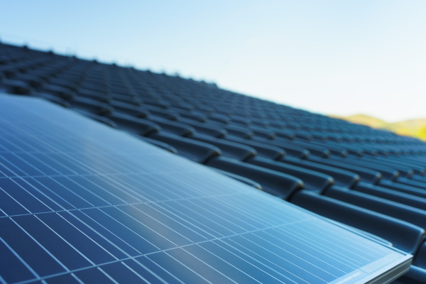 Close-up of solar photovoltaic panels on a roof, alternative energy, saving resources and sustainable lifestyle concept.