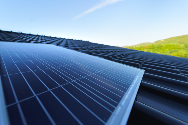 Close-up of solar photovoltaic panels on a roof, alternative energy, saving resources and sustainable lifestyle concept.