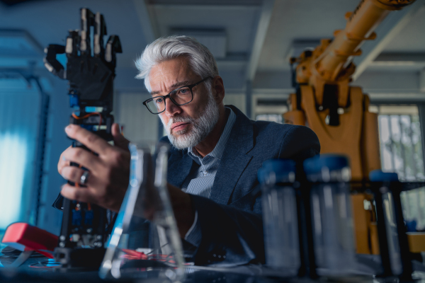 Robotics engineer adjusting, calibring robotic prosthetic artificial hand. Concept of modern technology in medicine. Robotic prosthetics, biomechatronics and neuroscience.