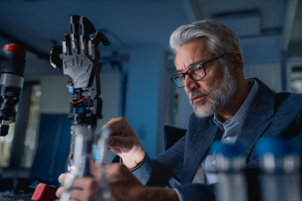 Robotics engineer adjusting, calibring robotic prosthetic artificial hand. Concept of modern technology in medicine. Robotic prosthetics, biomechatronics and neuroscience.