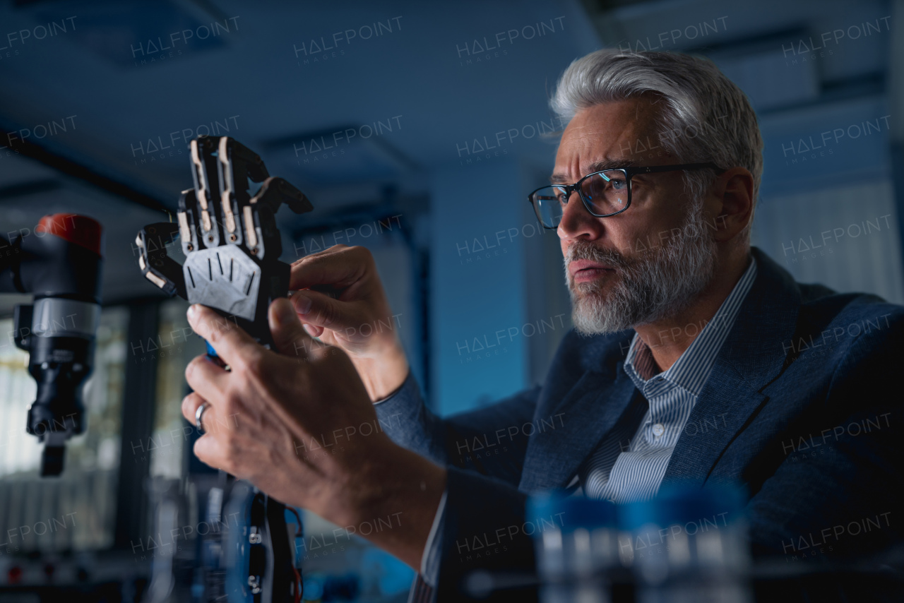 Robotics engineer adjusting, calibring robotic prosthetic artificial hand. Concept of modern technology in medicine. Robotic prosthetics, biomechatronics and neuroscience.