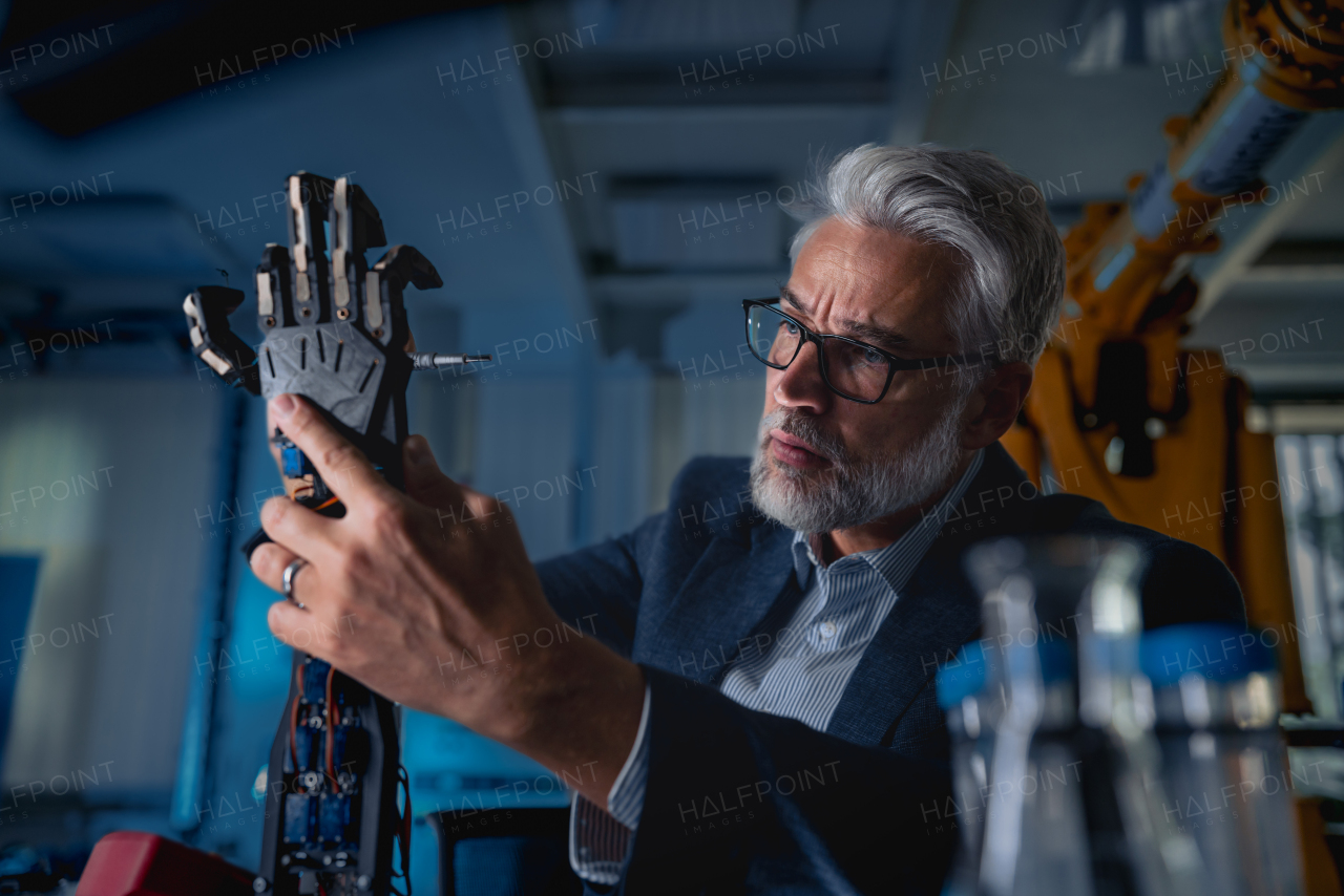 Robotics engineer adjusting, calibring robotic prosthetic artificial hand. Concept of modern technology in medicine. Robotic prosthetics, biomechatronics and neuroscience.