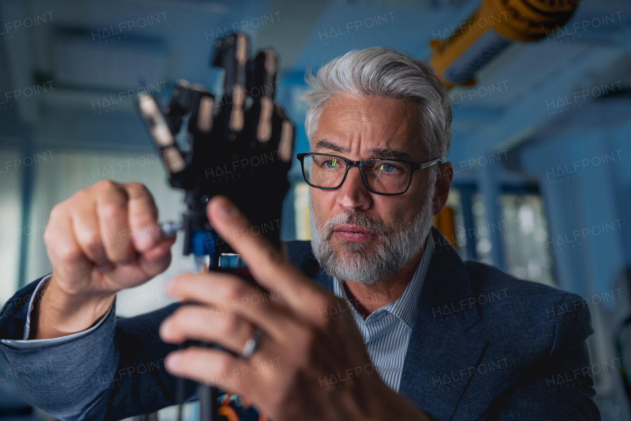 Robotics engineer adjusting, calibring robotic prosthetic artificial hand. Concept of modern technology in medicine. Robotic prosthetics, biomechatronics and neuroscience.