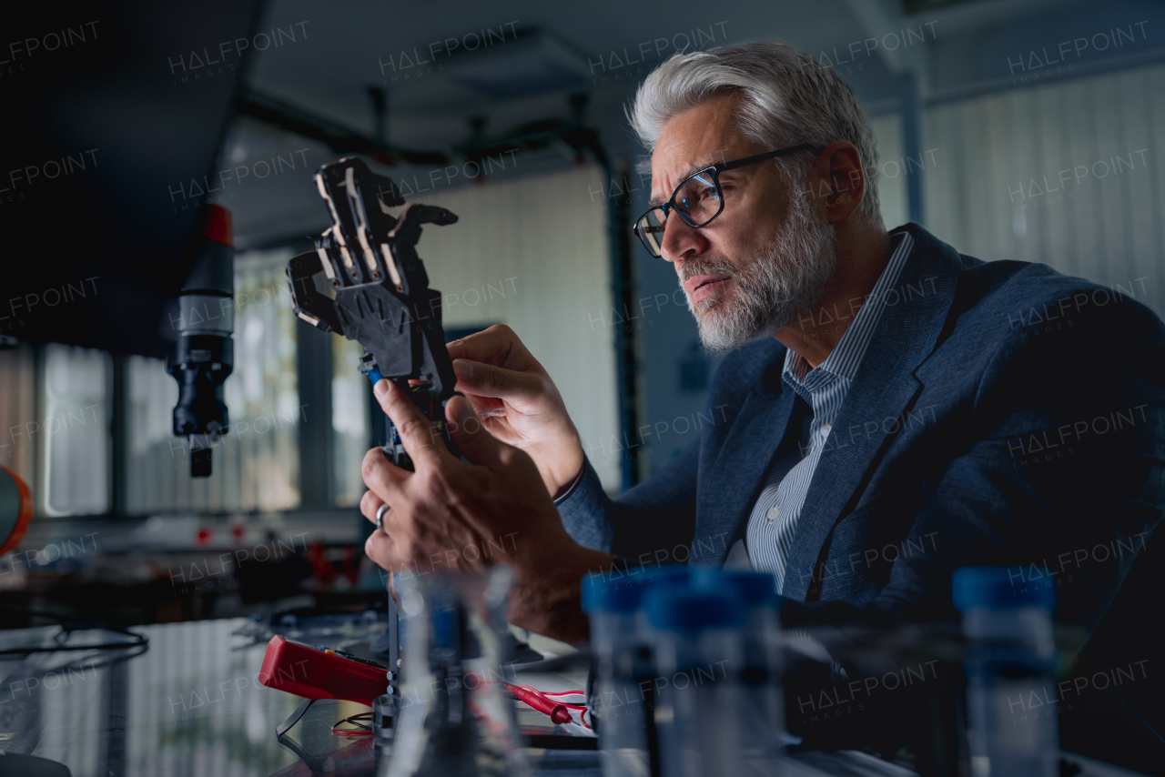 Robotics engineer adjusting, calibring robotic prosthetic artificial hand. Concept of modern technology in medicine. Robotic prosthetics, biomechatronics and neuroscience.