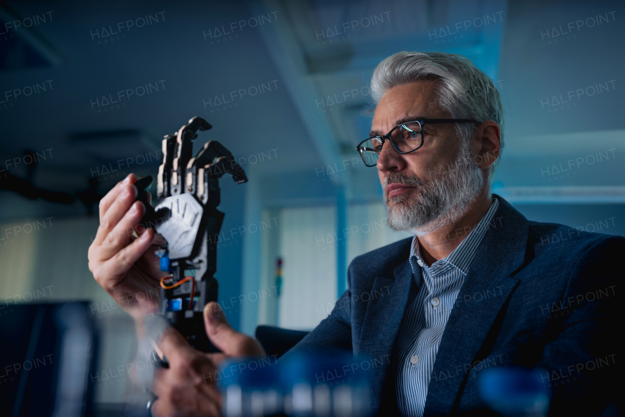 Robotics engineer adjusting, calibring robotic prosthetic artificial hand. Concept of modern technology in medicine. Robotic prosthetics, biomechatronics and neuroscience.