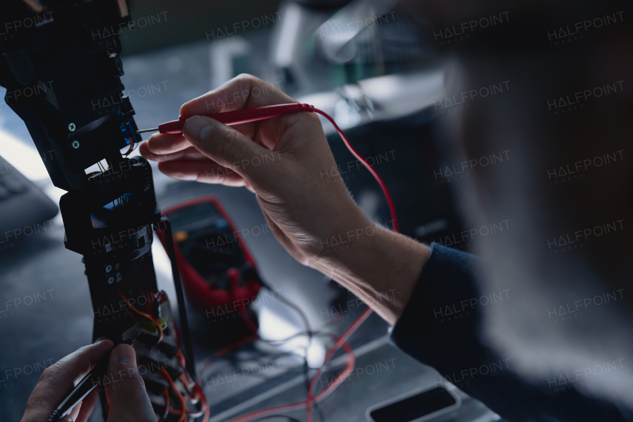 Close up of hand of robotics engineer adjusting, calibring robotic prosthetic hand. Concept of modern technology in medicine. Robotic prosthetics, biomechatronics and neuroscience.