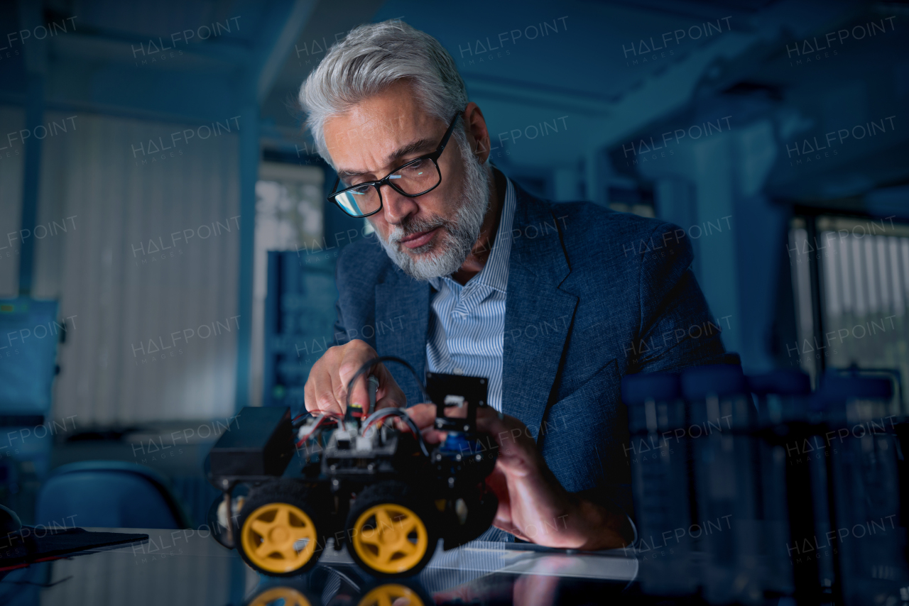 Automation, robotics engineer assembling robotic car. Concept of modern technology in industries, automated processes, automotive.