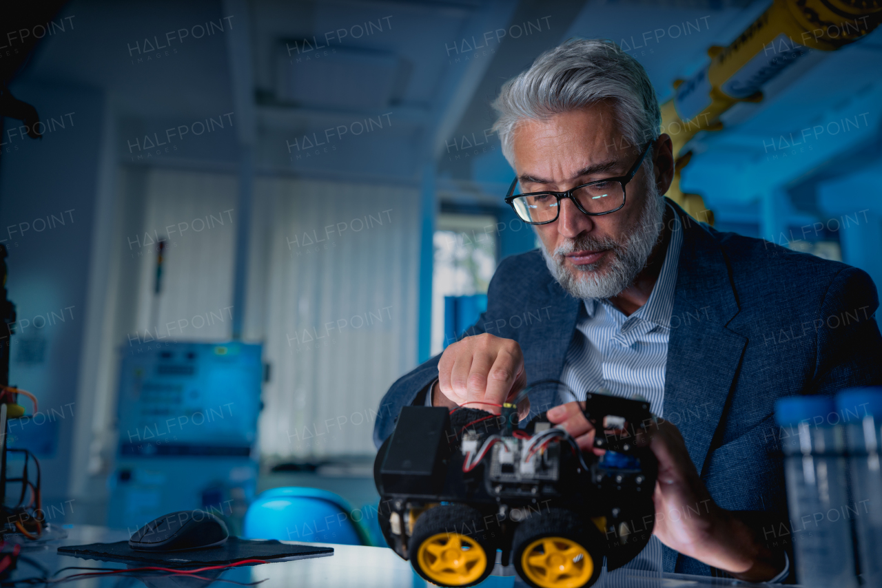 Automation, robotics engineer assembling robotic car. Concept of modern technology in industries, automated processes, automotive.