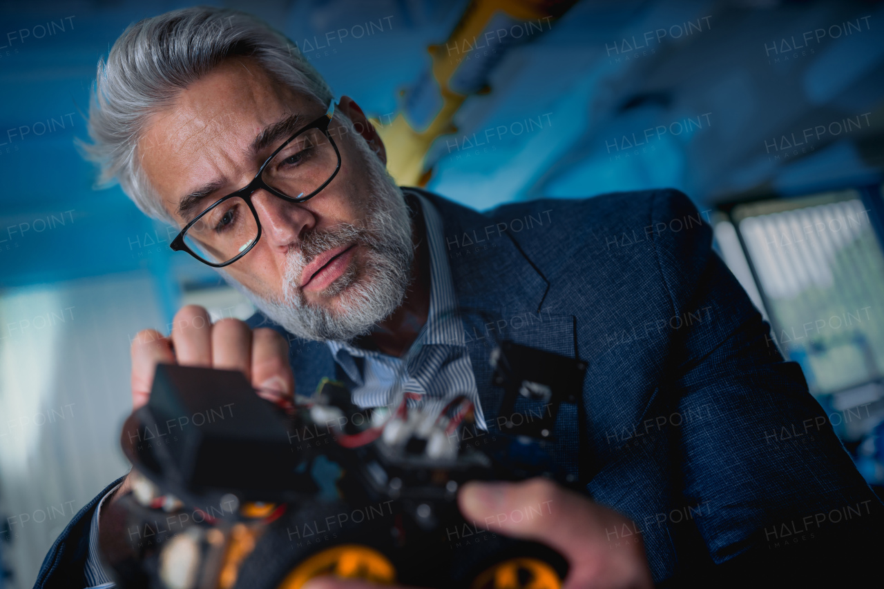 Automation, robotics engineer assembling robotic car. Concept of modern technology in industries, automated processes, automotive.