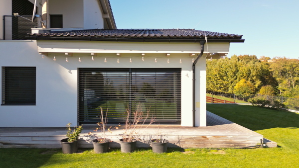 Modern eco house with solar panels on roof. Sustainability concept.