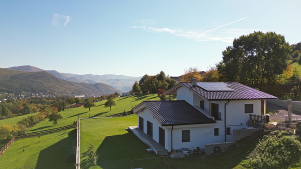 Photovoltaic panels on roof of modern eco house in beautiful nature.