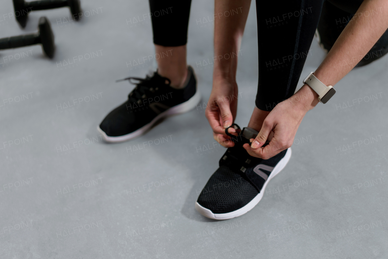 A close-up of woman Hands Tying Shoelaces On Fashion Sneakers