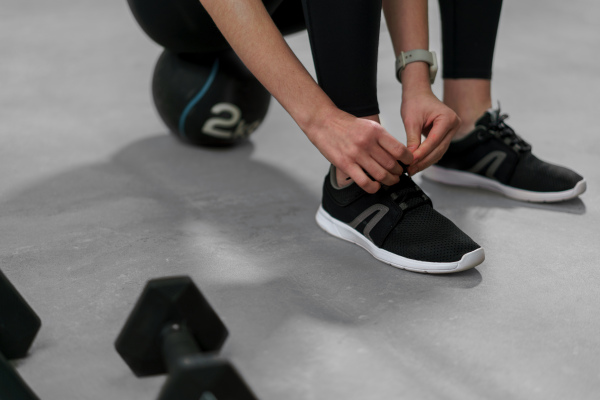 A close-up of woman Hands Tying Shoelaces On Fashion Sneakers