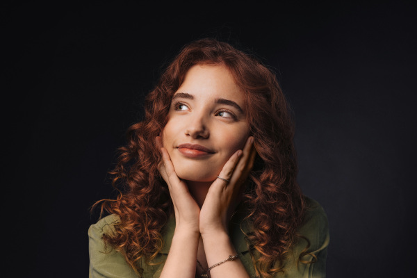 Portrait of a young redhead woman, studio shoot.