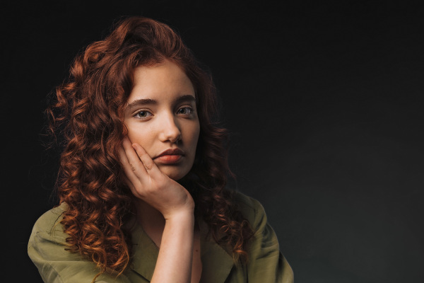 Portrait of young bored girl in a studio.