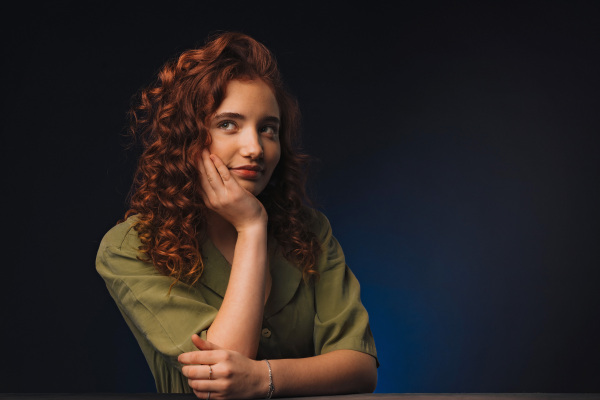 Portrait of a young redhead woman, studio shoot.