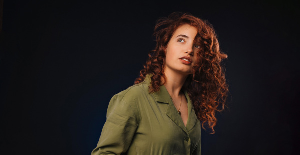 Portrait of a young redhead woman, studio shoot.