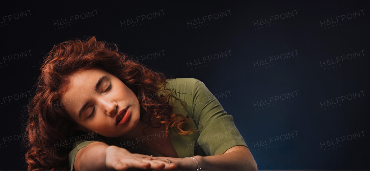 Portrait of a young redhead woman, studio shoot.