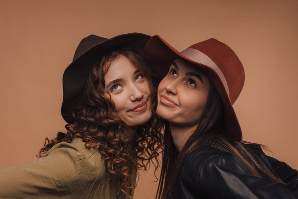 Portrait of two young happy friends, studio shoot,