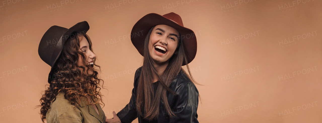 Portrait of two young happy friends, studio shoot,