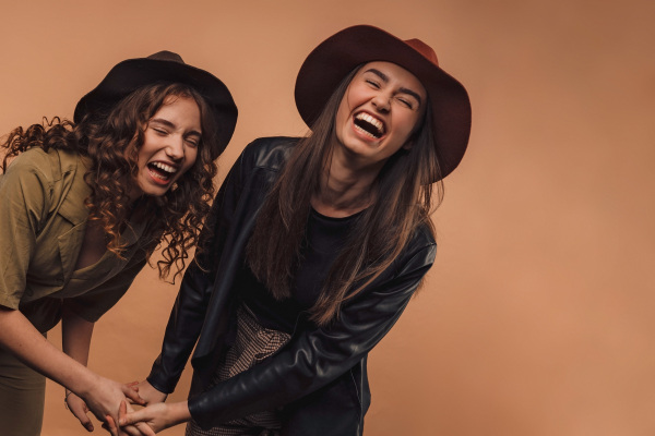 Portrait of two young happy friends, studio shoot,