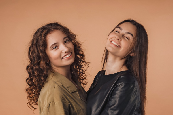 Portrait of two young happy friends, studio shoot,