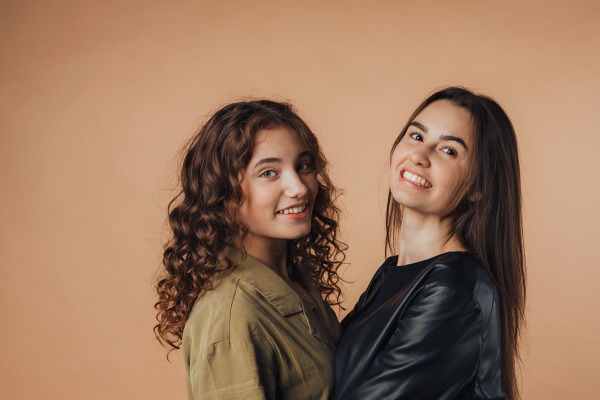 Portrait of two young happy friends, studio shoot,