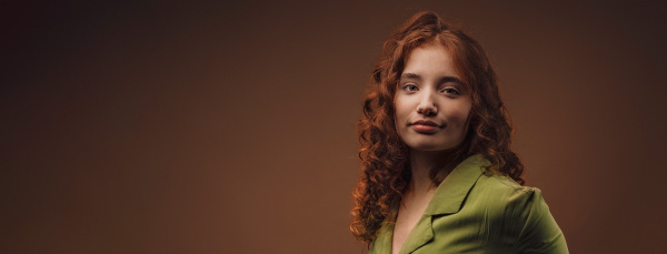 Portrait of a young redhead woman, studio shoot.