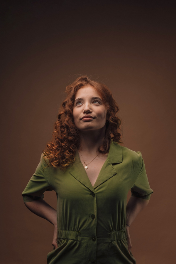 Portrait of a young redhead woman, studio shoot.