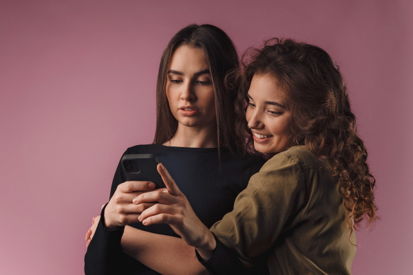 Portrait of two young happy friends, studio shoot,