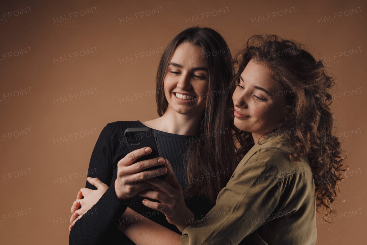 Portrait of two young happy friends, studio shoot,