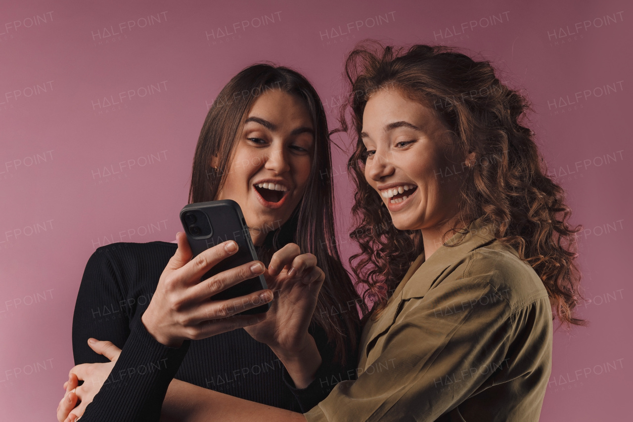 Portrait of two young happy friends, studio shoot,