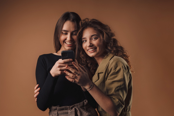 Portrait of two young happy friends, studio shoot,