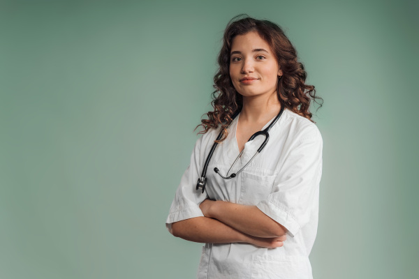 Portrait of a young curly nurse, studio shoot.