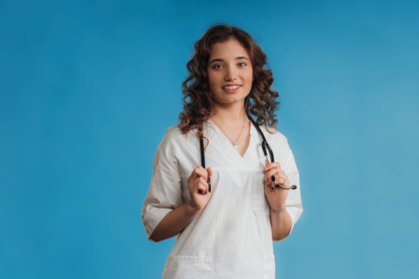 Portrait of a young curly nurse, studio shoot.