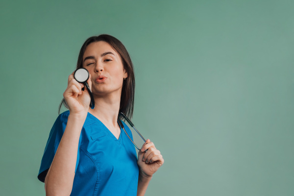 Portrait of young nurse with a stethoscope, studio shoot.