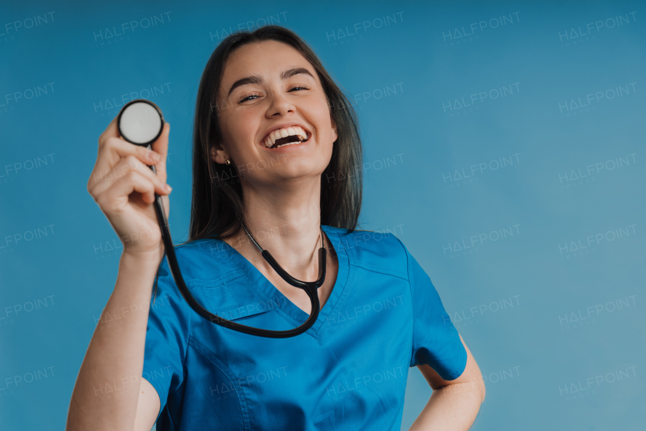 Portrait of young nurse with a stethoscope, studio shoot.