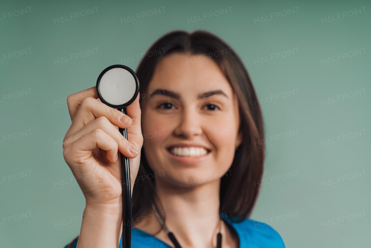 Portrait of young nurse with a stethoscope, studio shoot.