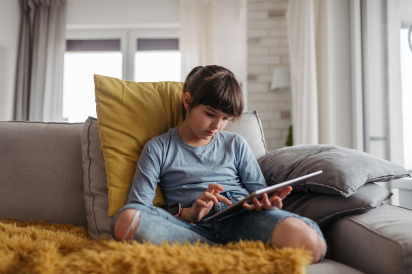 Young schoolgirl struggling with learning at home, doing homework. Learning difficulties in children.