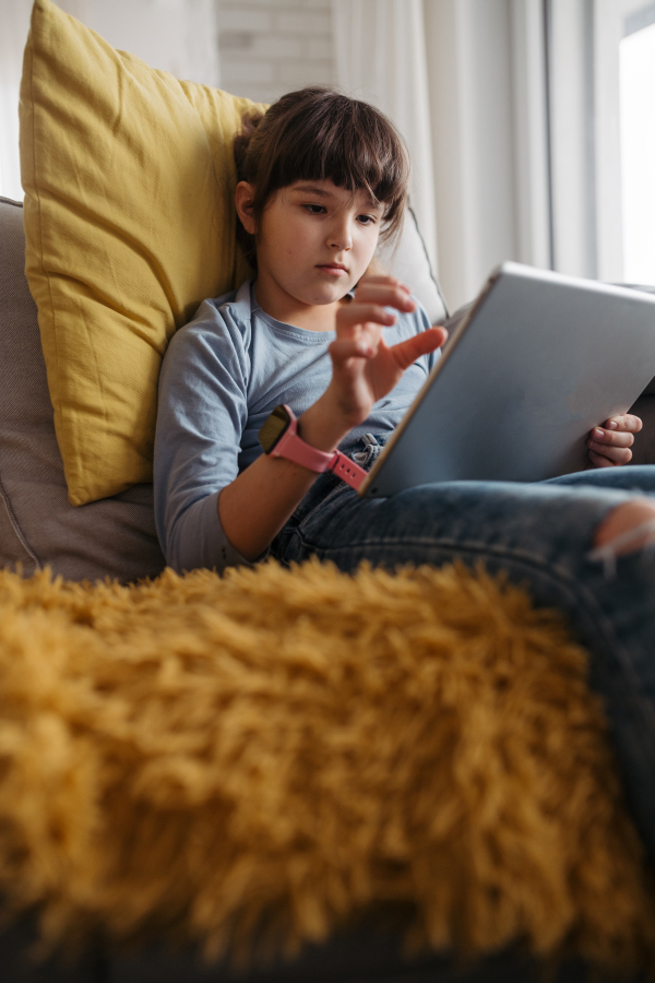 Young schoolgirl struggling with learning at home, doing homework. Learning difficulties in children.