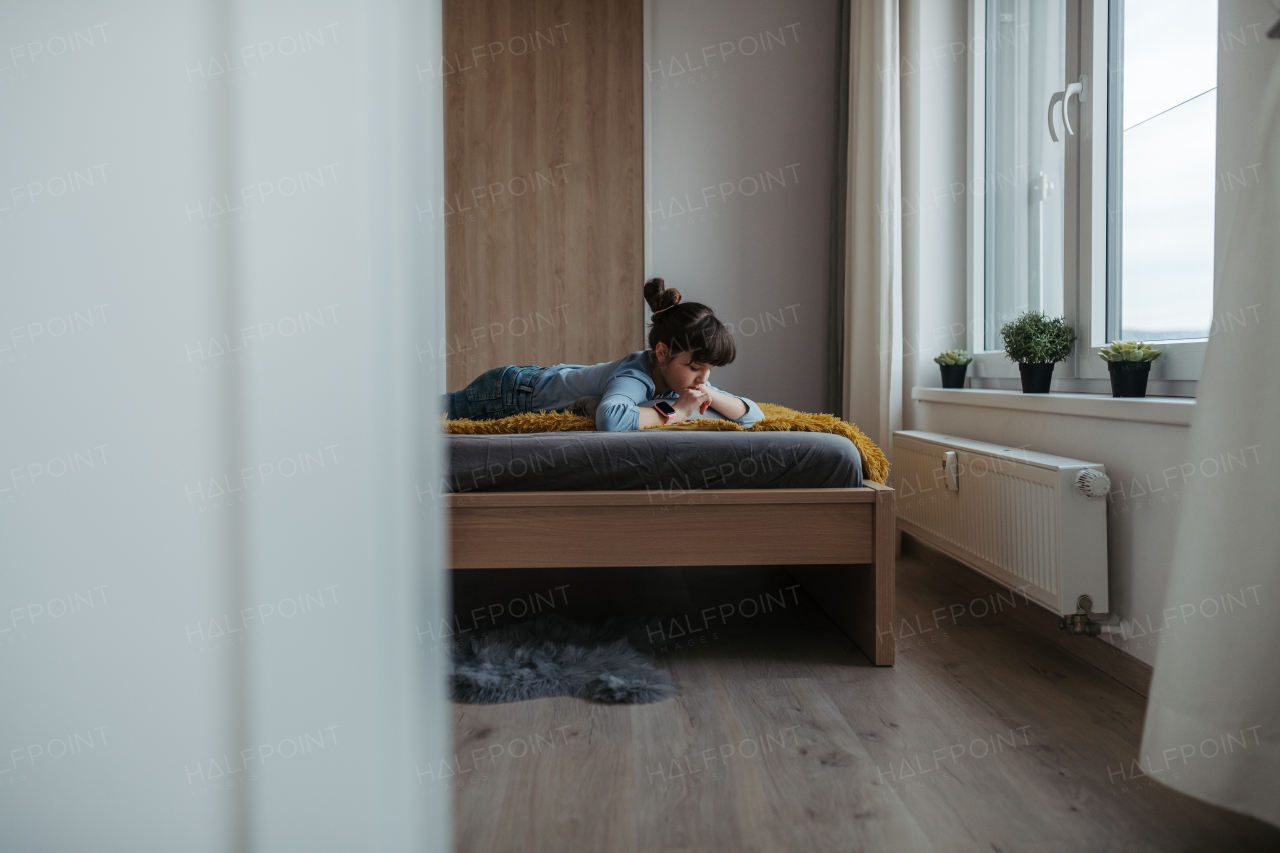 Young schoolgirl struggling with learning at home, doing homework. Learning difficulties in children.