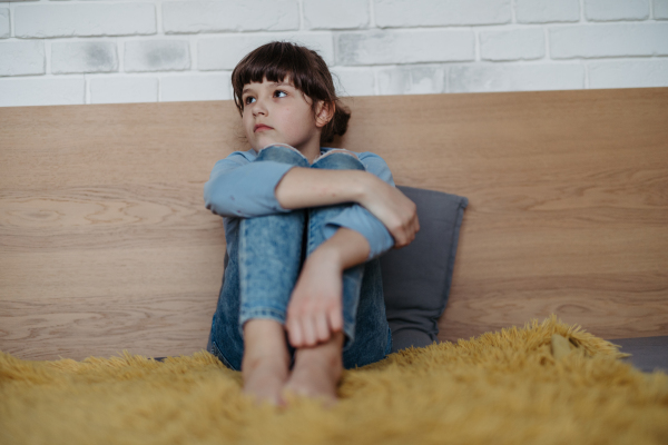 Young schoolgirl struggling with learning at home, doing homework. Learning difficulties in children.