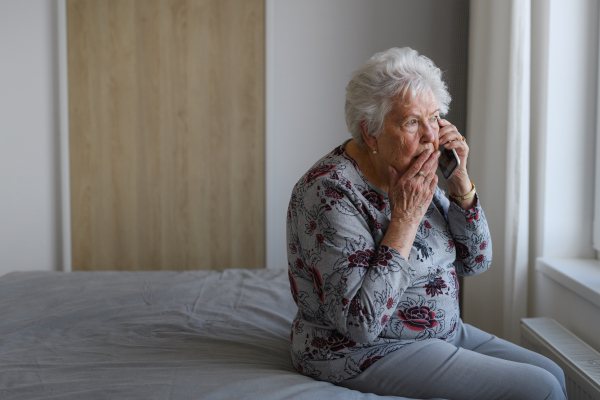 Senior woman making phone call, receiving bad news. Concept of loneliness and dependence of old people.