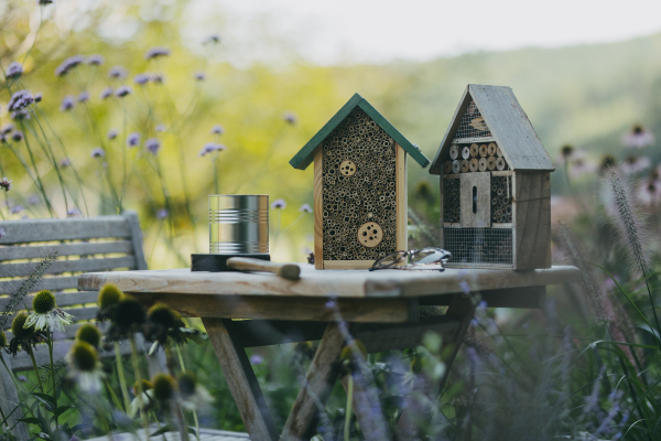 Wooden insect house outdoors in the garden. Bug hotel as home for many species of insects, garden ecosystem and biodiversity. DIY project.