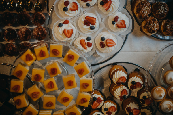 Top view of elegant, luxurious candy bar with freshly baked desserts and sweets. Desserts for party, wedding reception.