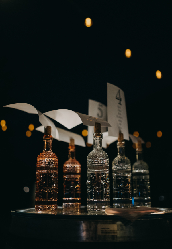 Decorative alcohol, liquor decanter displayed on table. Luxury bottles with cork as holder.