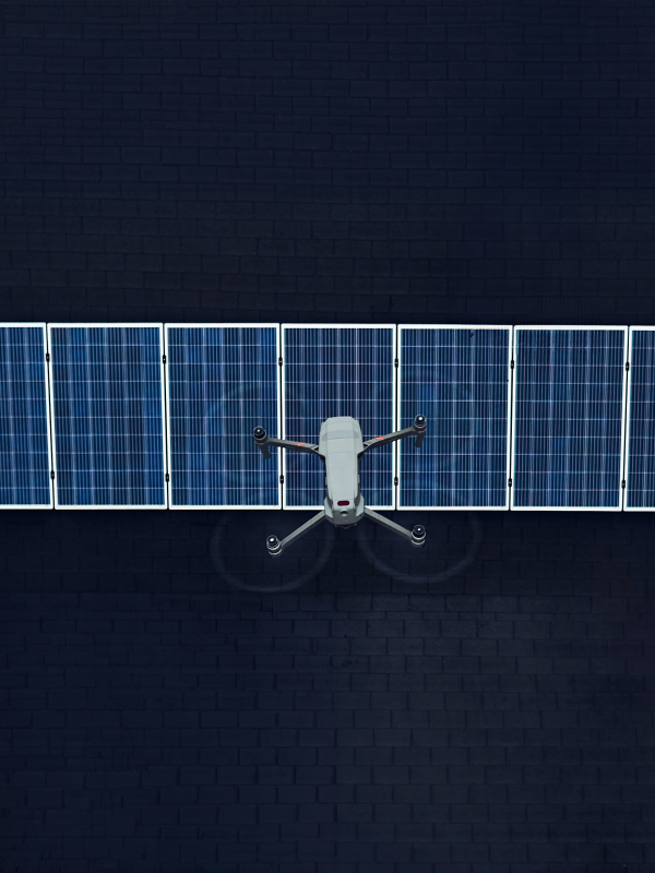 Aerial view of a drone flying over solar panels on rooftop. Solar energy as renewable energy source.