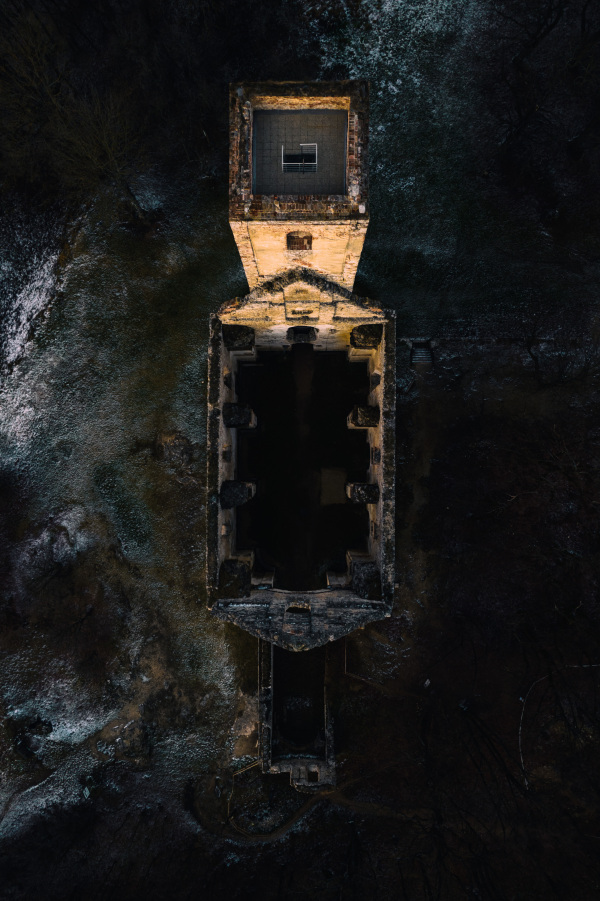 Aerial view of an old abandoned building, skyscraper in the city. Top view of old derelict building in a bad state.