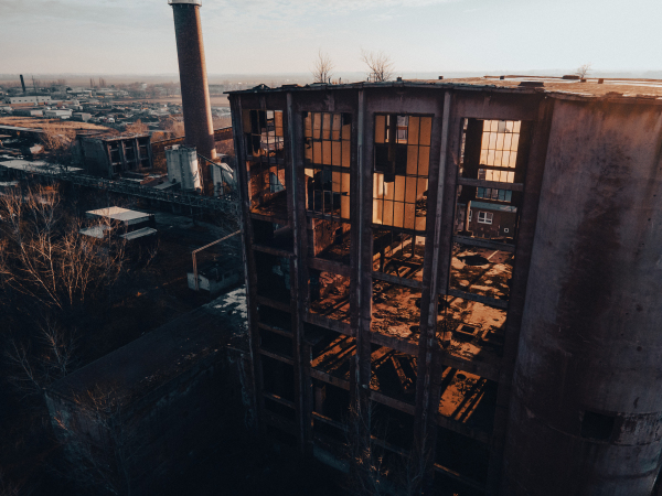 Aerial view of an old abandoned building, skyscraper in the city. Old derelict building in a bad state.